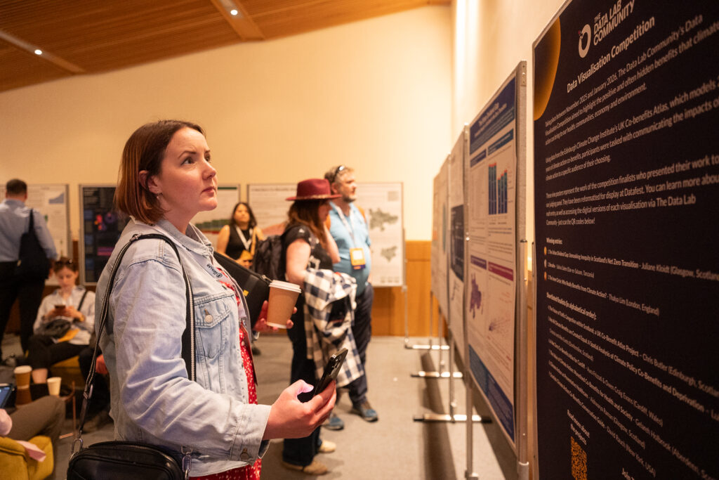 DataFest 2026 attendee looking at data viz poster display
